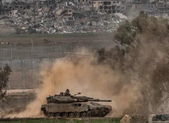 An Israeli army tank moves near the Gaza Strip border